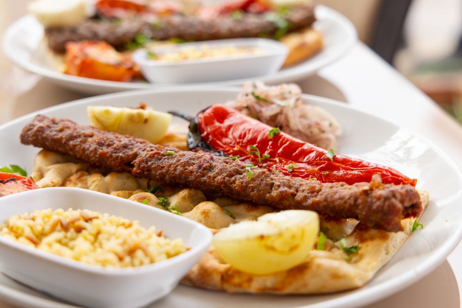 Brochettes de kebab grillées servies avec du riz parfumé et des légumes grillés