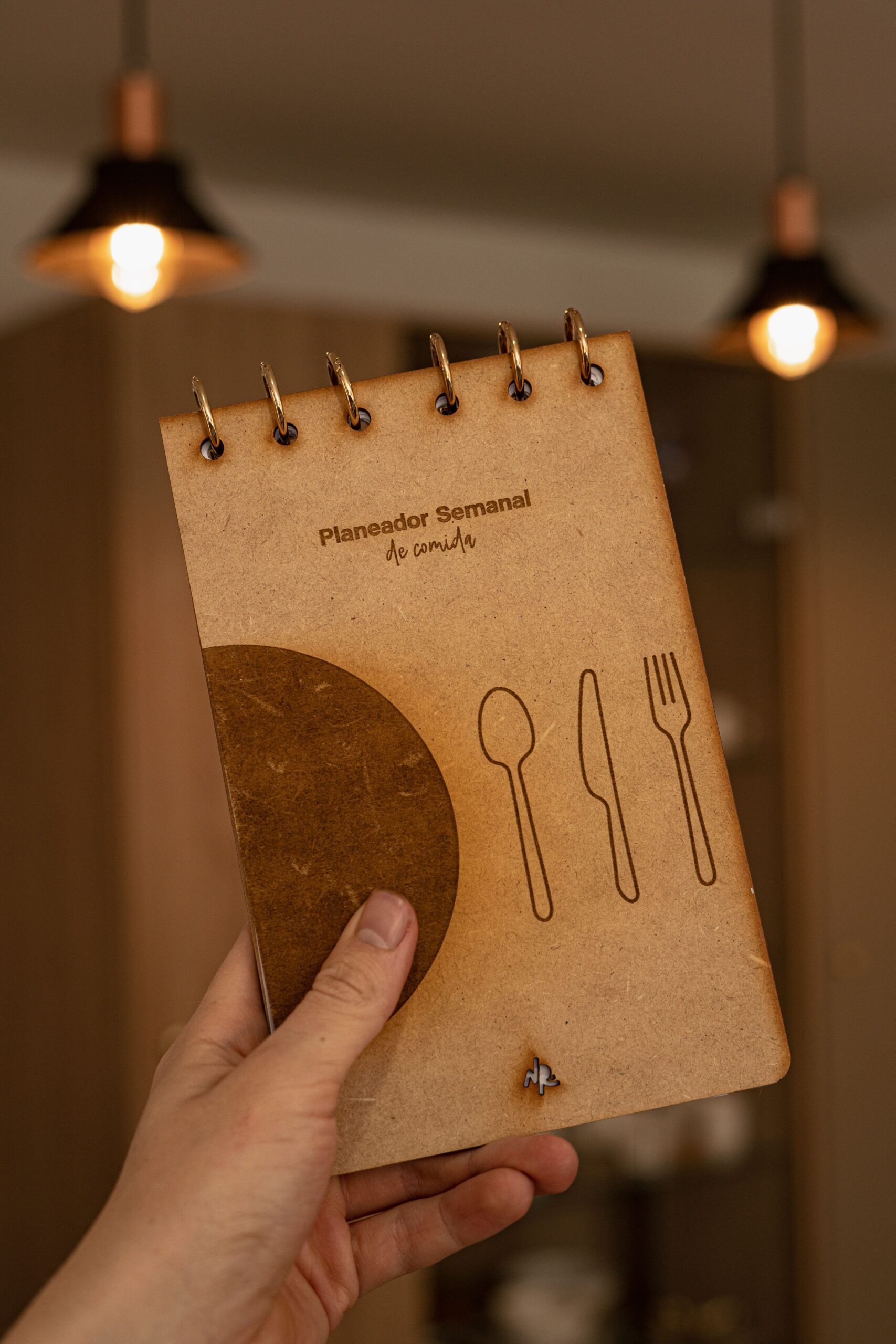 Weekly meal planning notebook with illustrated cutlery for organizing Ramadan menus
