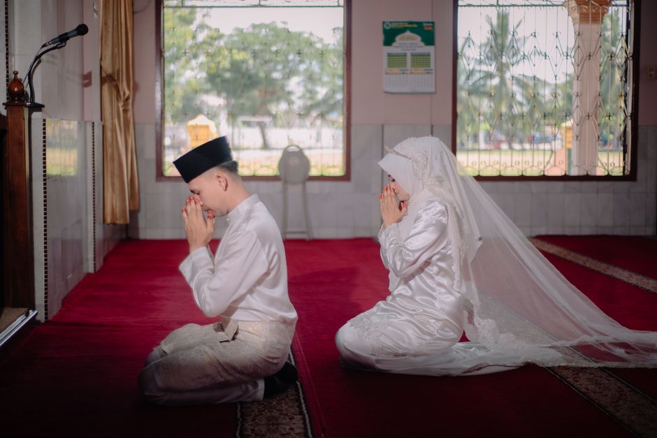 Muslim newlyweds praying side by side during their wedding ceremony in a mosque