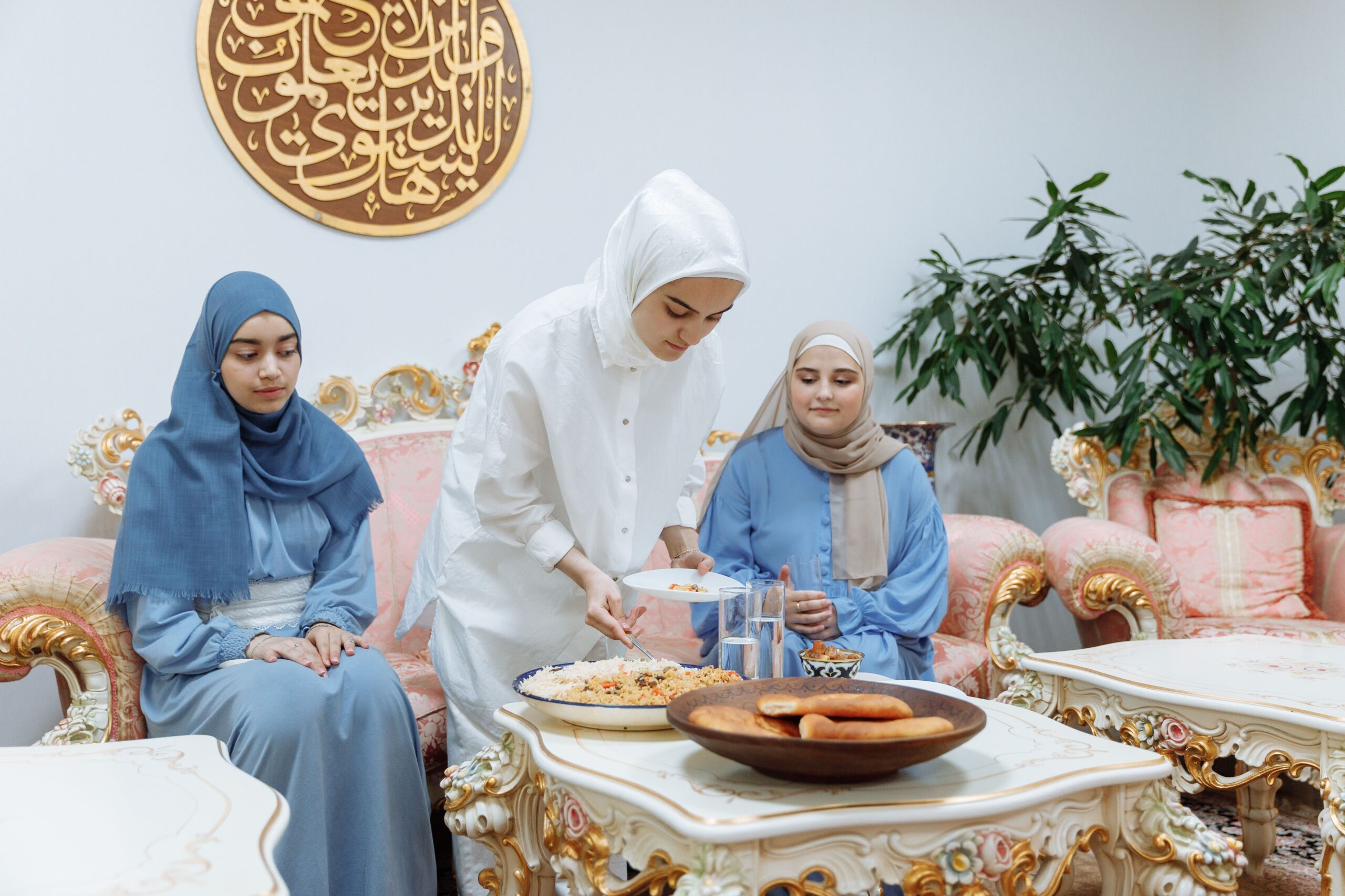 Muslim women in hijab preparing an iftar meal together in a warm atmosphere