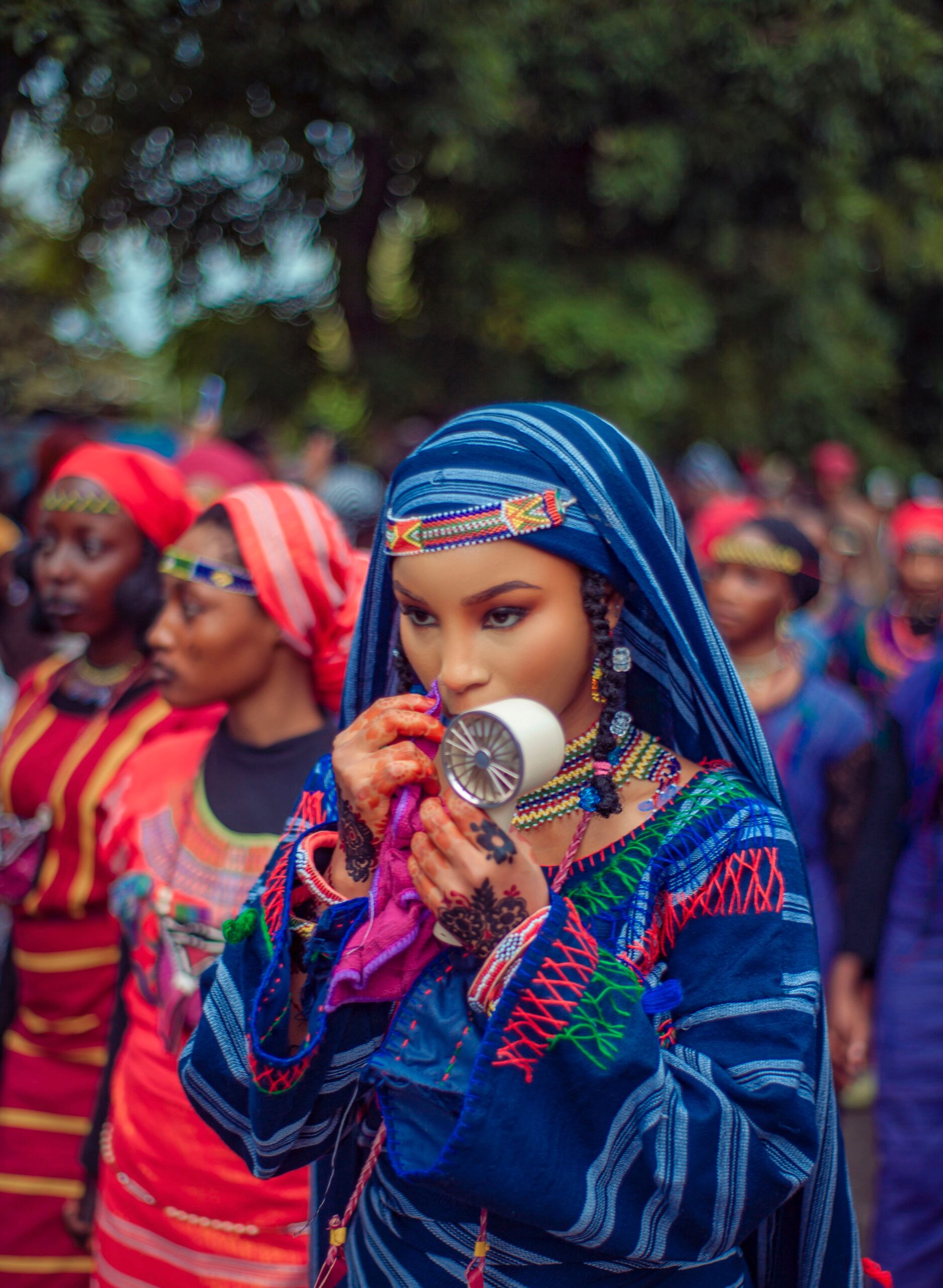 Young African woman in colorful traditional attire at a cultural festival