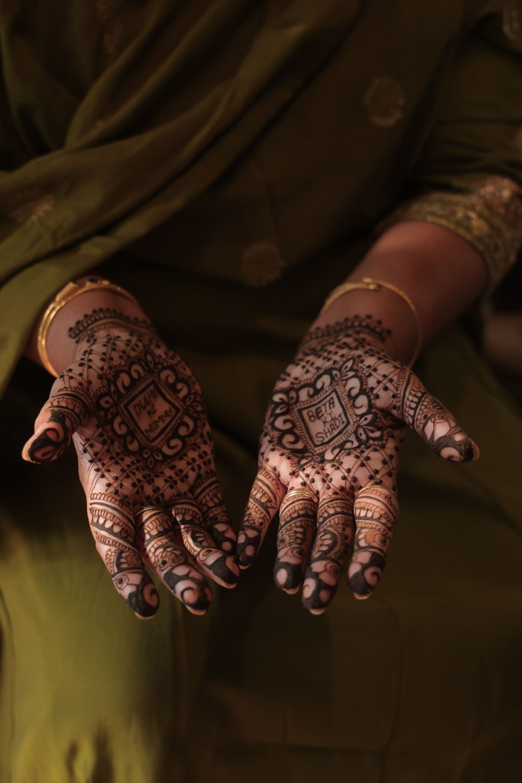 Woman's hands decorated with traditional henna patterns for a Muslim wedding