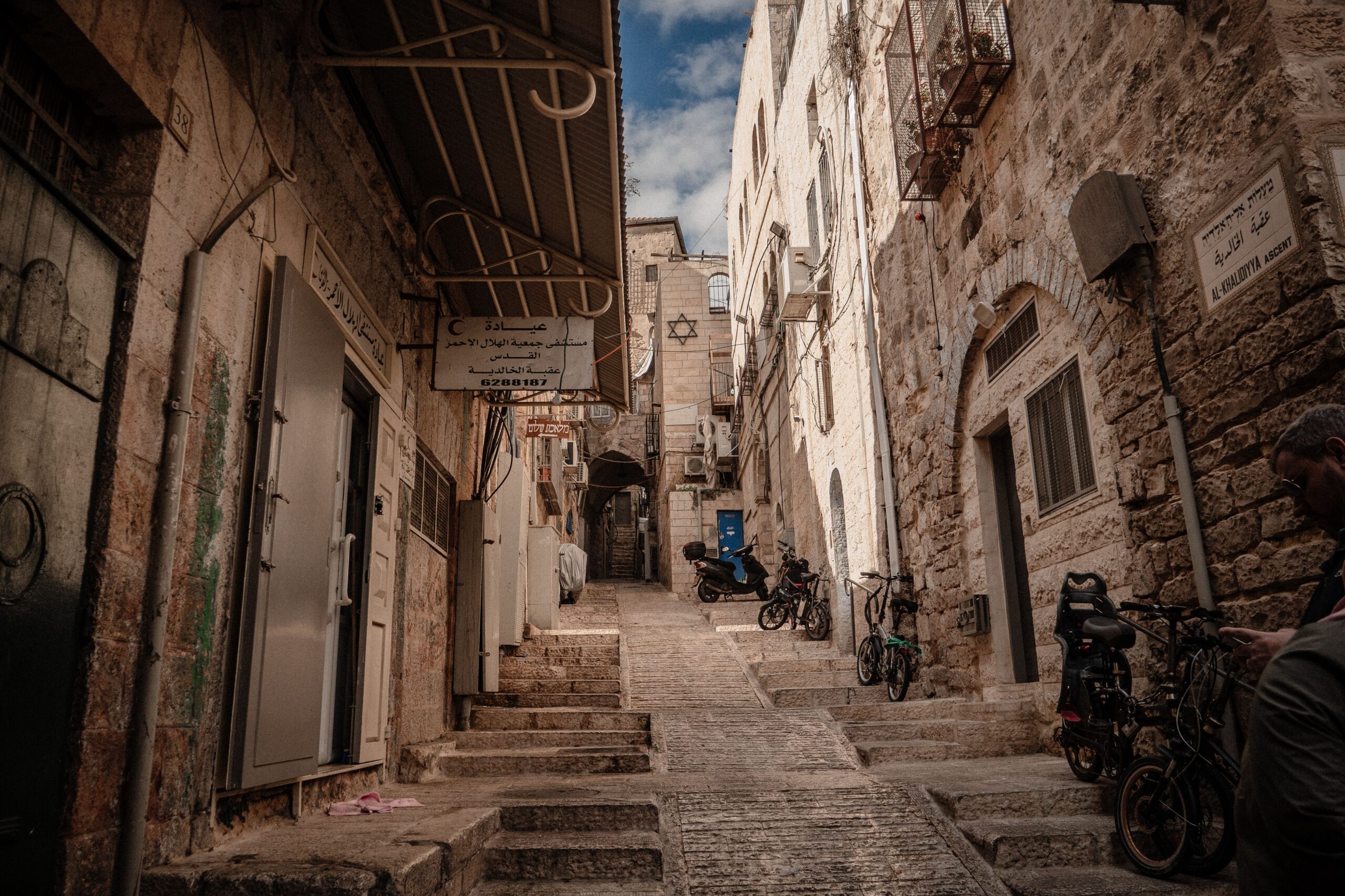 Picturesque cobblestone alley in the Old City of Jerusalem with stairs and bicycles