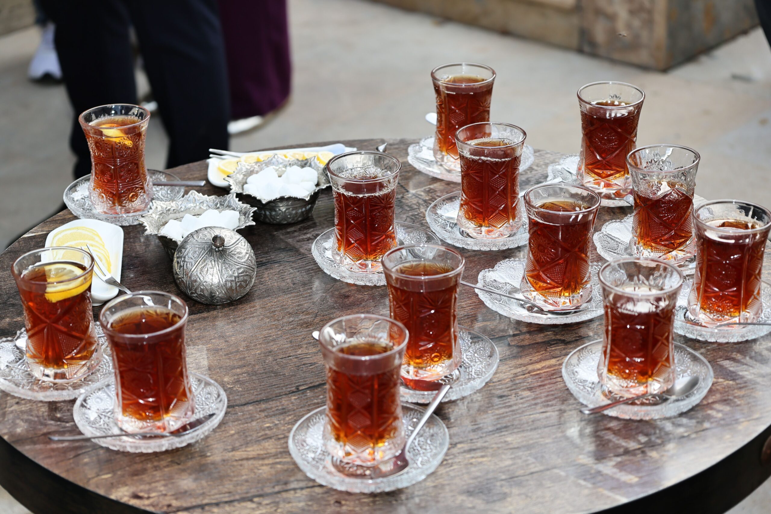 Traditional table with several Middle Eastern tea glasses arranged on glass saucers