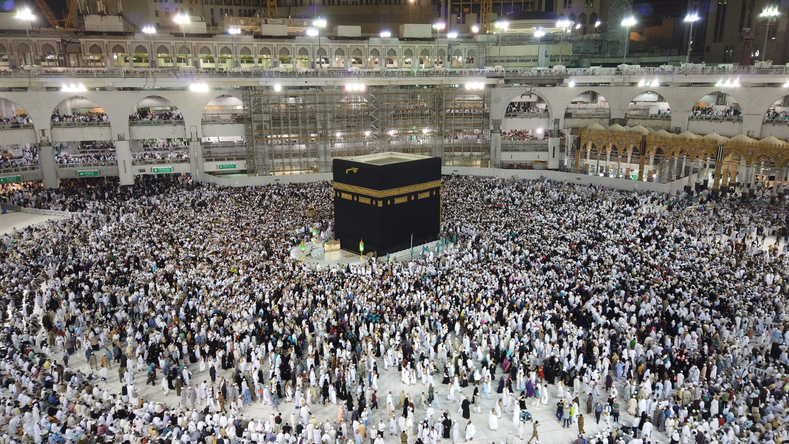 Vue aérienne de milliers de pèlerins en ihram blanc rassemblés autour de la Kaaba à La Mecque la nuit